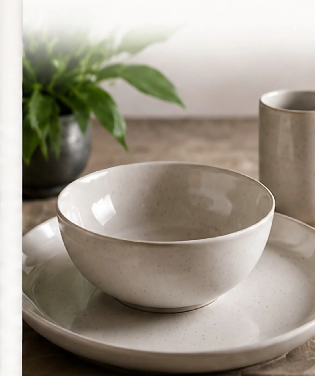 A hard glazed bowl, plate and mug on a stone counter